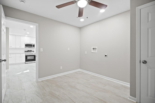 clothes washing area featuring electric dryer hookup, washer hookup, a ceiling fan, baseboards, and laundry area