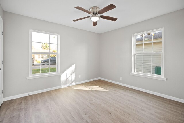 spare room with ceiling fan, baseboards, and wood finished floors