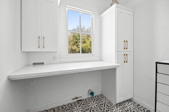 office area featuring baseboards and built in desk