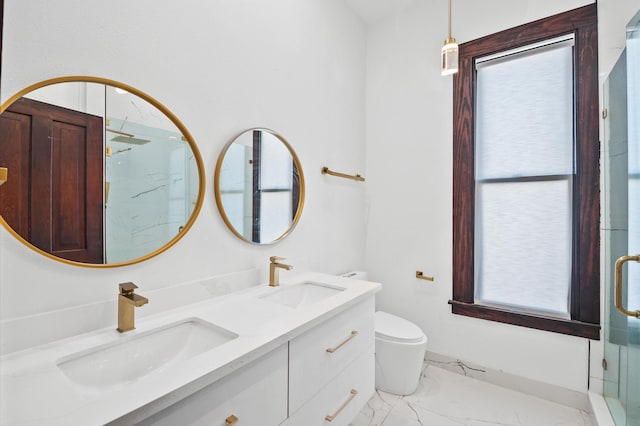 bathroom featuring a sink, toilet, marble finish floor, and a shower stall