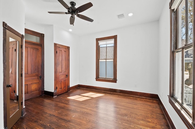 unfurnished bedroom featuring visible vents, a ceiling fan, recessed lighting, baseboards, and dark wood-style flooring