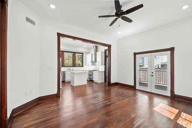 empty room featuring dark wood-type flooring, a ceiling fan, recessed lighting, french doors, and baseboards