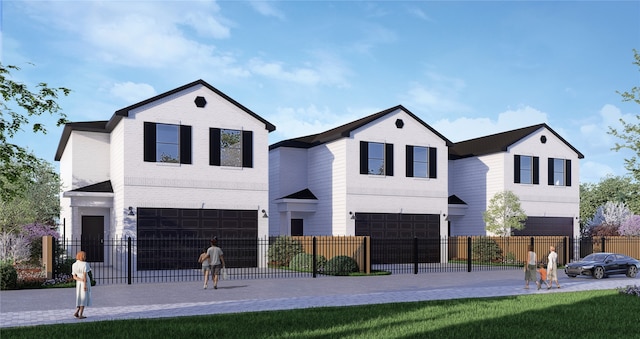 view of front facade featuring a fenced front yard, an attached garage, and driveway