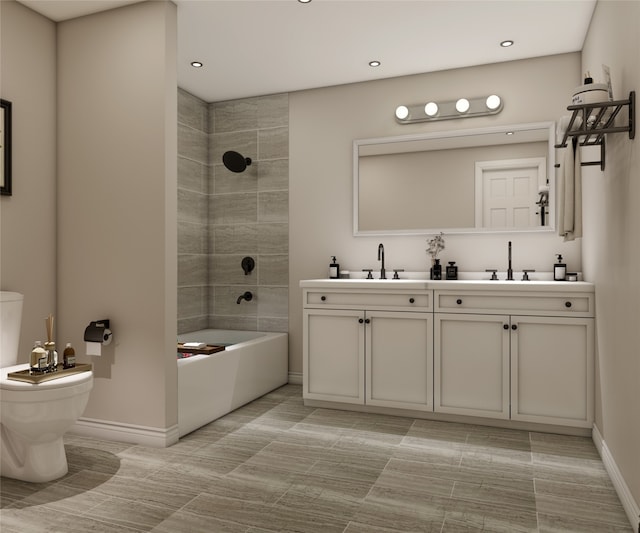 bathroom featuring double vanity, toilet, baseboards, and a sink