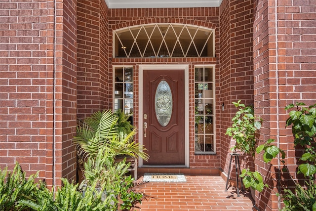 property entrance with brick siding