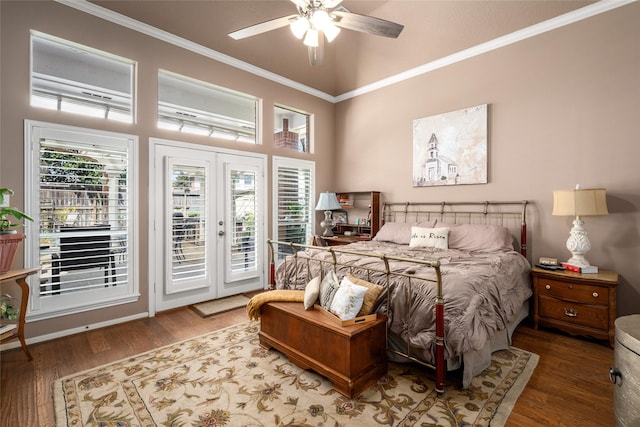 bedroom with access to exterior, multiple windows, wood finished floors, and ornamental molding