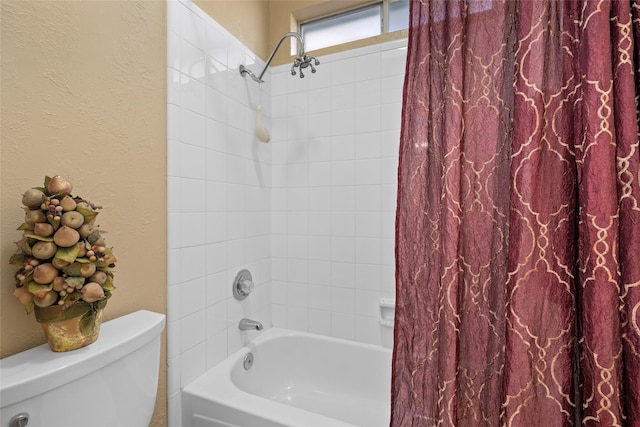 bathroom featuring toilet, a textured wall, and shower / tub combo with curtain