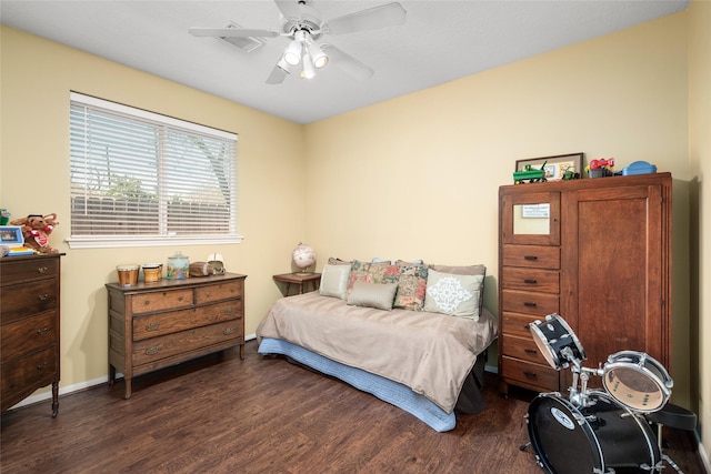 bedroom featuring ceiling fan, baseboards, and dark wood-style flooring