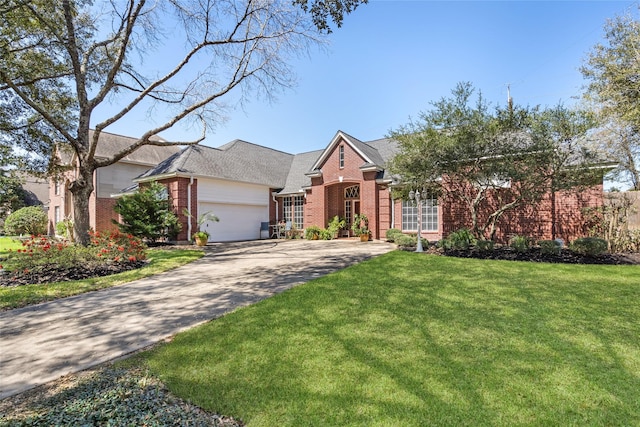 view of front facade with a front lawn, a garage, brick siding, and driveway