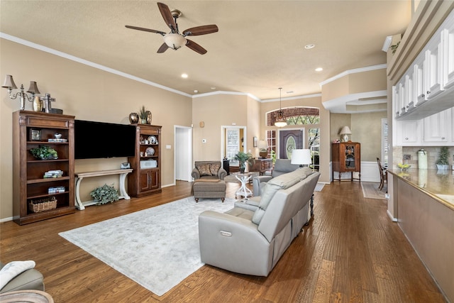 living area featuring dark wood finished floors, crown molding, recessed lighting, and ceiling fan