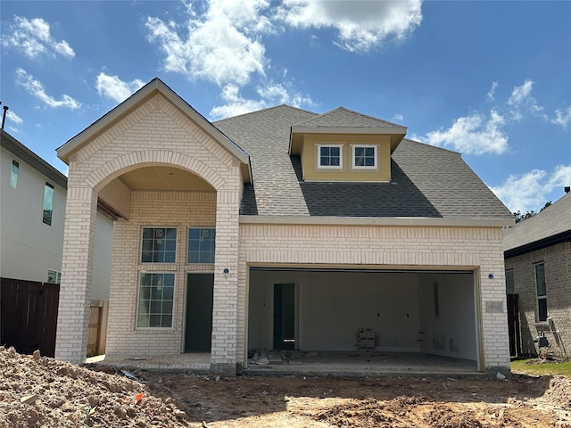 view of front facade with a garage and brick siding