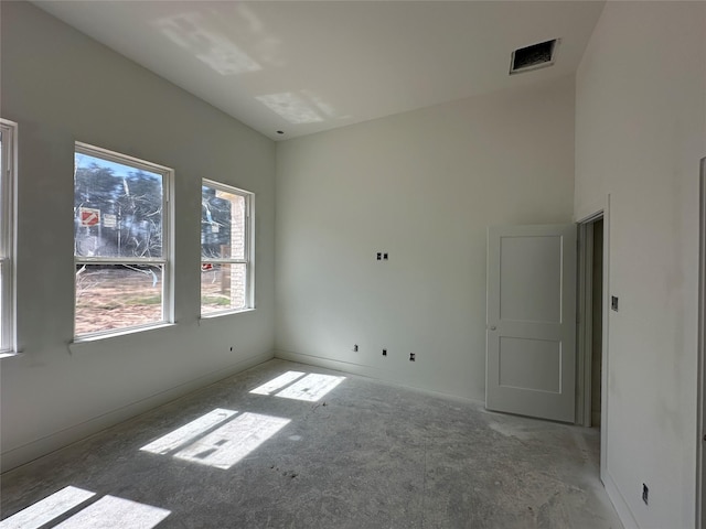 unfurnished room with visible vents and baseboards