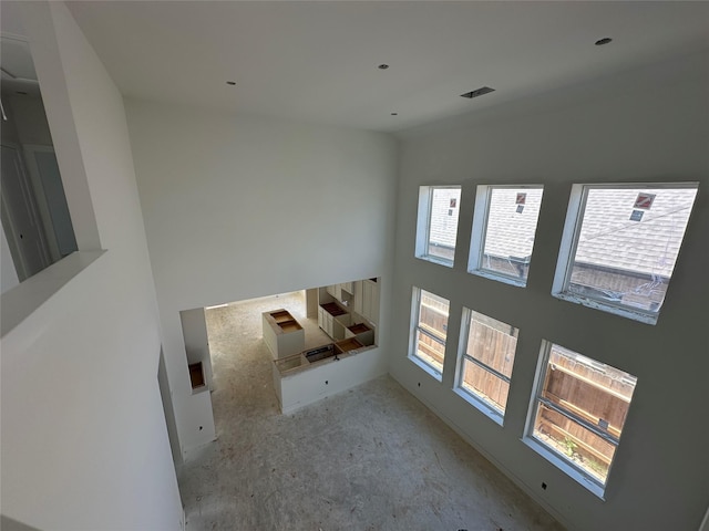 unfurnished living room with visible vents