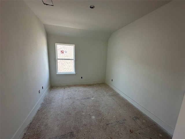 unfurnished room featuring vaulted ceiling