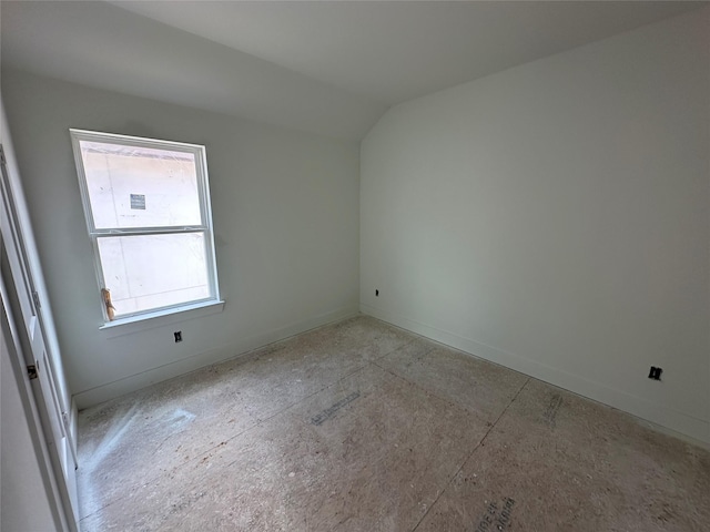 spare room with lofted ceiling