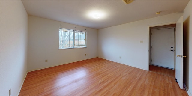 spare room featuring visible vents and light wood-style flooring