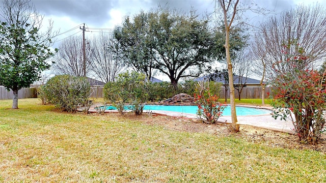 view of pool with a fenced in pool, a lawn, and a fenced backyard