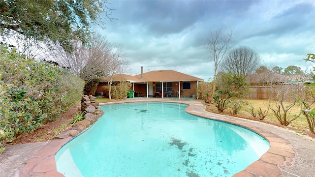 view of pool with a fenced in pool and fence