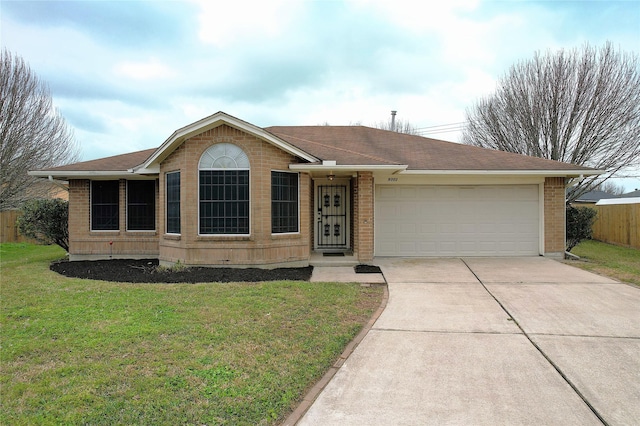 ranch-style house with a front yard, fence, driveway, a garage, and brick siding