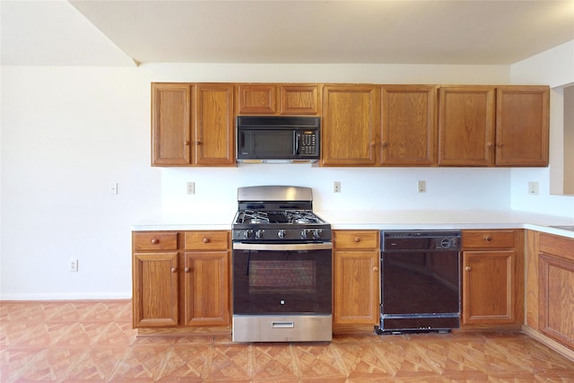 kitchen featuring black appliances, brown cabinetry, and light countertops