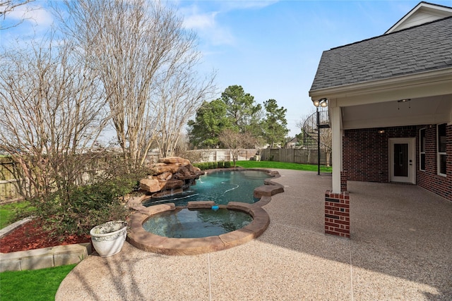 view of swimming pool with a patio area, a pool with connected hot tub, stairs, and a fenced backyard