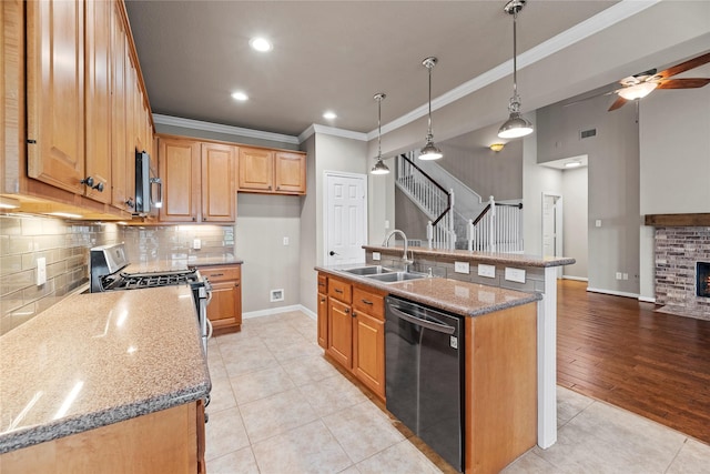 kitchen featuring a sink, appliances with stainless steel finishes, light tile patterned flooring, crown molding, and a brick fireplace