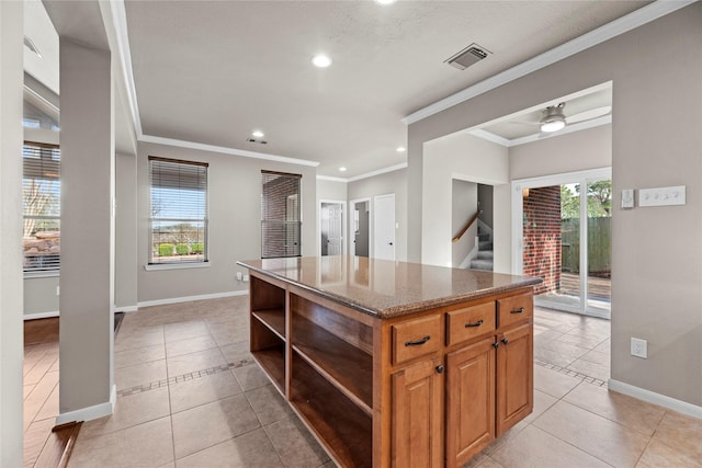 kitchen featuring dark stone countertops, light tile patterned floors, visible vents, open shelves, and a center island