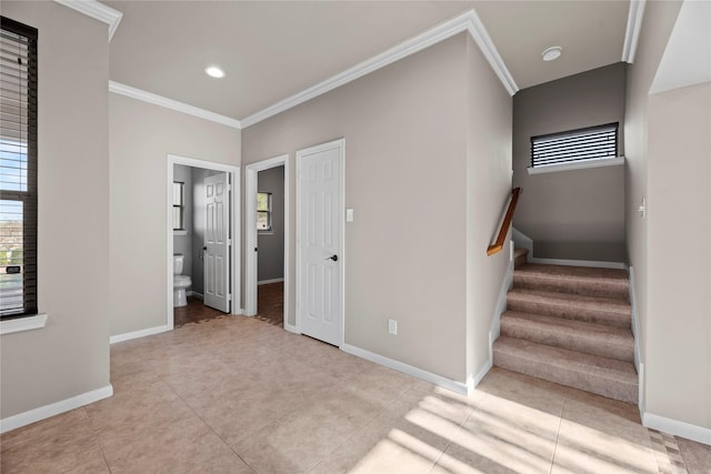 stairs with baseboards, a healthy amount of sunlight, and ornamental molding