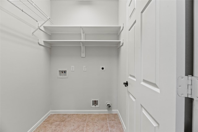 washroom featuring light tile patterned floors, baseboards, laundry area, electric dryer hookup, and washer hookup