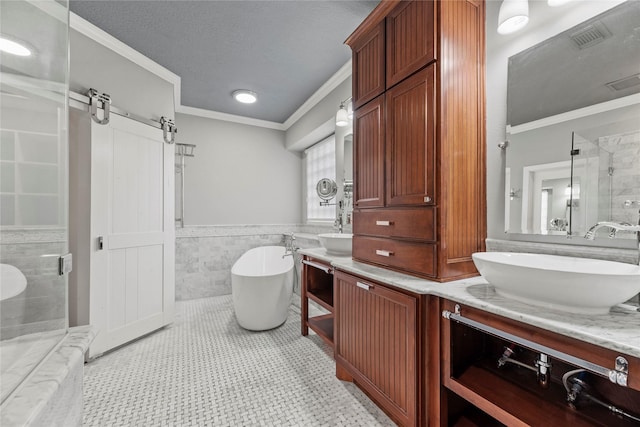 bathroom featuring wainscoting, a stall shower, a soaking tub, a textured ceiling, and a sink