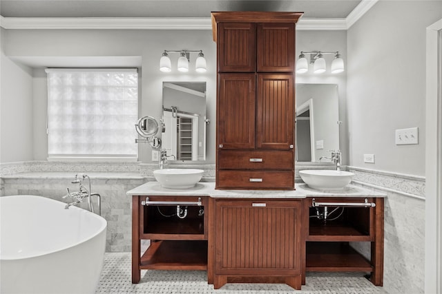 bathroom featuring a wainscoted wall, double vanity, a freestanding tub, a sink, and crown molding