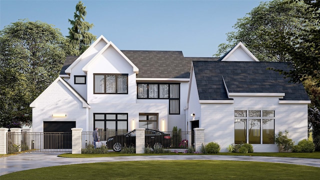 view of front of home featuring a fenced front yard, driveway, a front lawn, and a garage