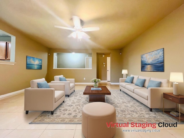 living area with baseboards, a ceiling fan, and tile patterned flooring