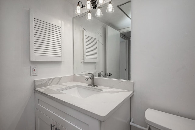 half bathroom with vanity and toilet