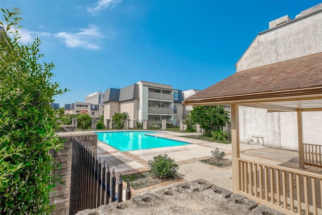 pool featuring a patio area and fence