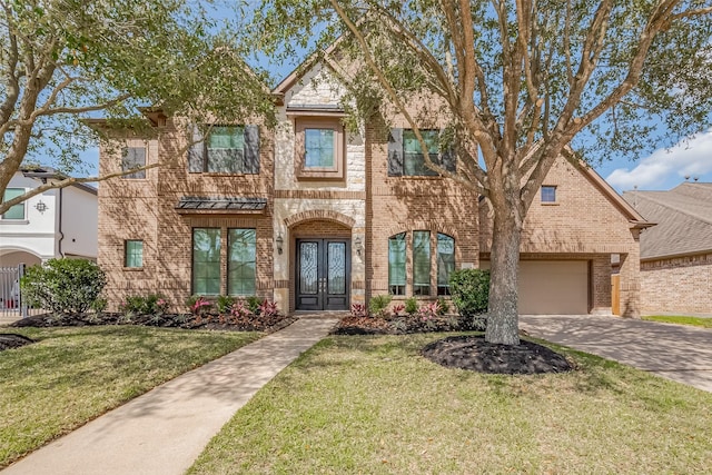 view of front of house with french doors, brick siding, concrete driveway, and a front lawn