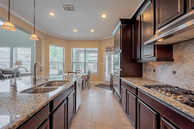 kitchen featuring visible vents, ornamental molding, stainless steel appliances, a sink, and under cabinet range hood