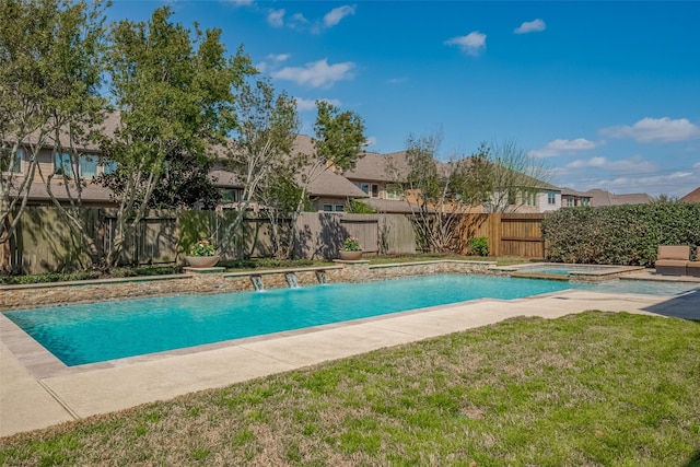 view of swimming pool with a yard, a residential view, a fenced backyard, and a pool with connected hot tub