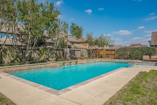 view of pool featuring a patio, a pool with connected hot tub, and a fenced backyard