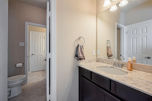 bathroom featuring tile patterned floors, toilet, and vanity