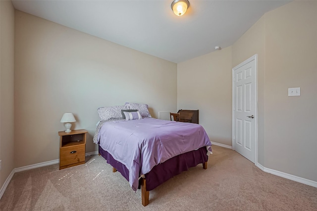 carpeted bedroom featuring baseboards