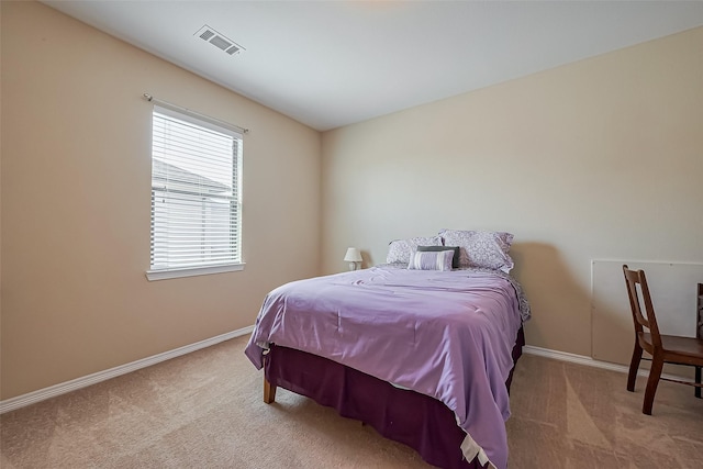 carpeted bedroom with visible vents and baseboards