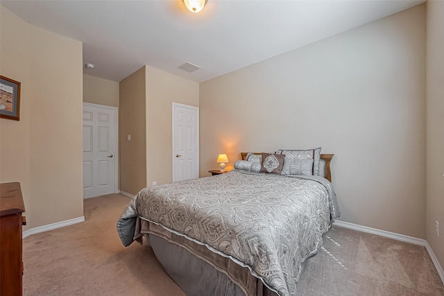 carpeted bedroom featuring visible vents and baseboards