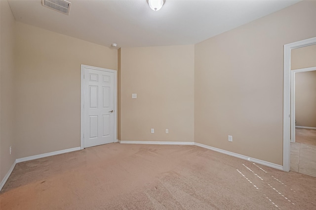 unfurnished bedroom with visible vents, light colored carpet, and baseboards