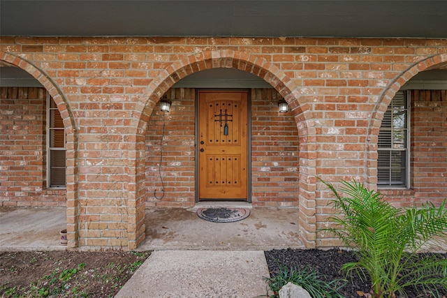 property entrance with brick siding