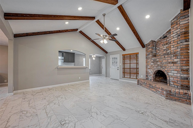 unfurnished living room with a brick fireplace, arched walkways, marble finish floor, and ceiling fan