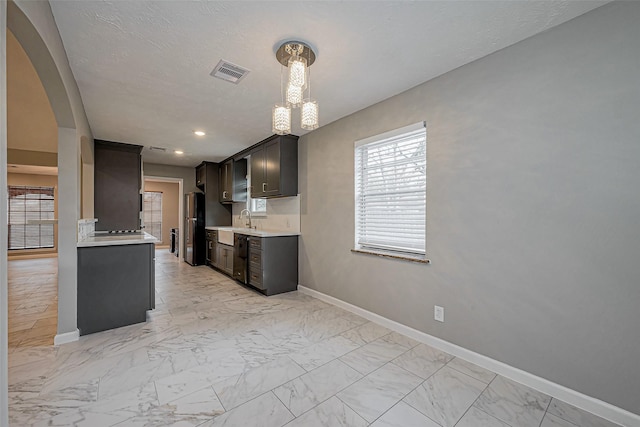 kitchen with visible vents, light countertops, marble finish floor, black appliances, and a sink