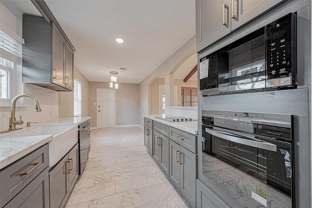 kitchen featuring marble finish floor, gray cabinets, and oven