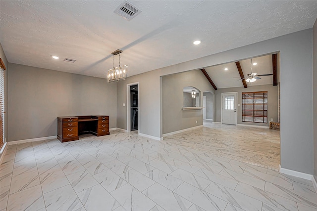 unfurnished living room with visible vents, ceiling fan with notable chandelier, lofted ceiling with beams, a textured ceiling, and arched walkways