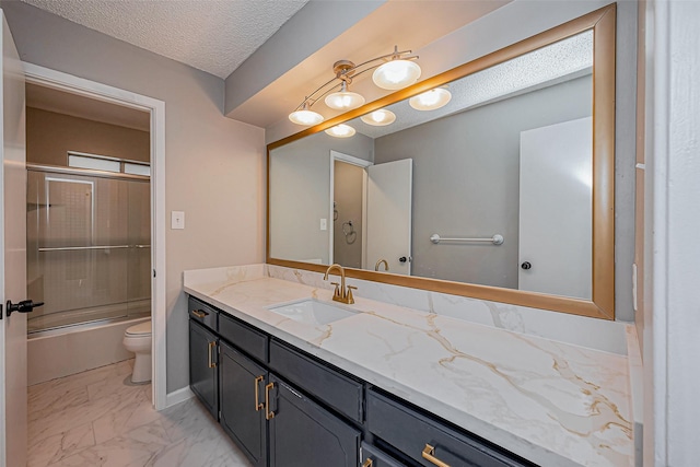 full bathroom with vanity, bath / shower combo with glass door, a textured ceiling, toilet, and marble finish floor